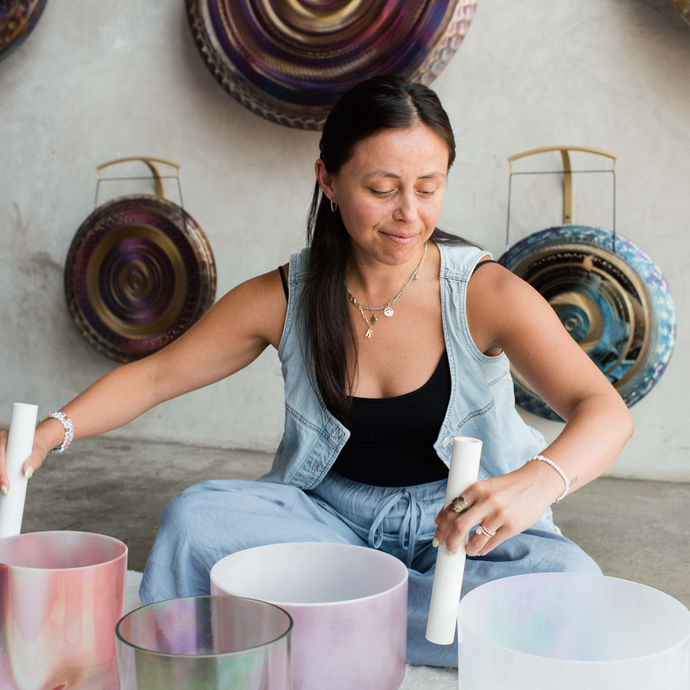 Sound healing training session where participants learn techniques with crystal singing bowls, earn certification, and practice leading sound baths