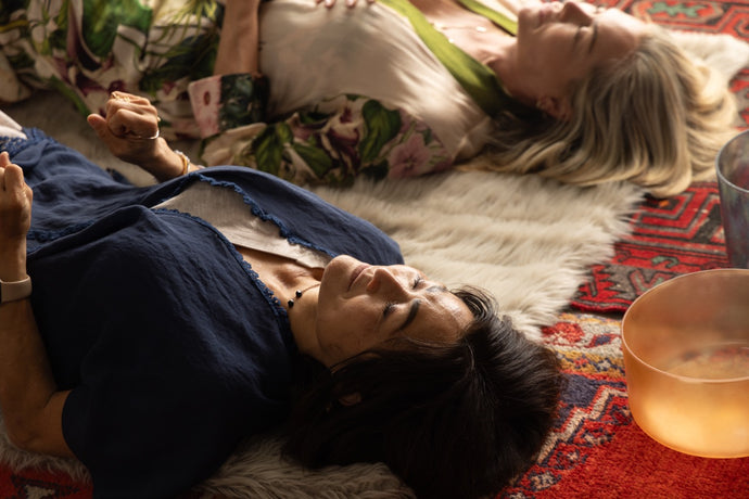 Two Women Lying Down with Eyes Closed Next to Singing Bowls - Immersive Sound Healing Experience for Restoration and Renewal at The Sound Healing Studio in Los Angeles