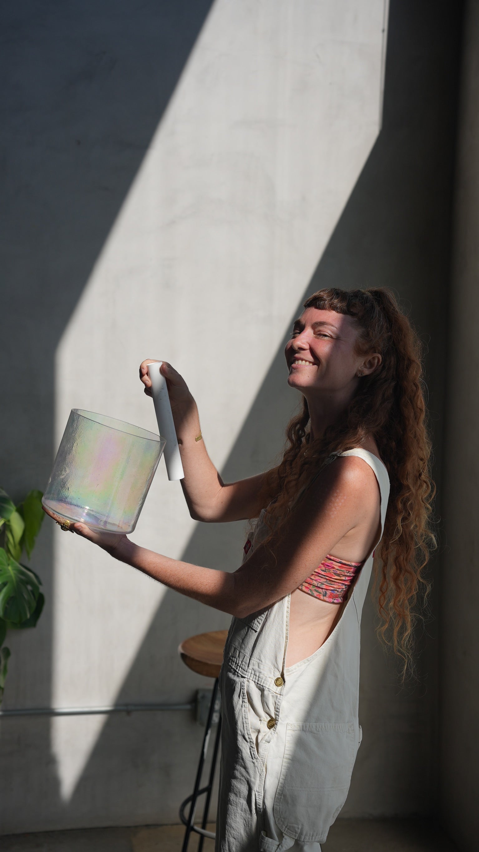 Smiling Woman Playing a Single Singing Bowl - Join The Sound Healing Studio's Inner Circle for Exclusive Invitations and Transformative Insights.