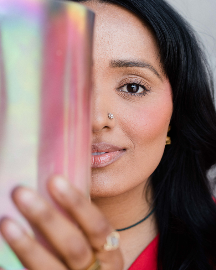 Image of a woman holding a crystal singing bowl, radiating calm and focus, symbolizing the transformative and healing energy of sound therapy practices