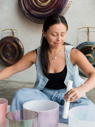 Sound healing training session where participants learn techniques with crystal singing bowls, earn certification, and practice leading sound baths