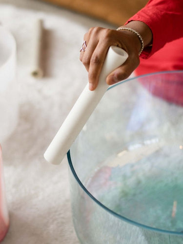 Sound healing practice session, featuring a practitioner using crystal singing bowls and other instruments to create soothing vibrations, fostering relaxation and inner balance.