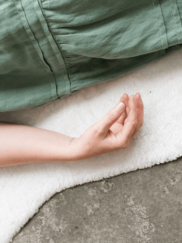 Serene sound healing experience, featuring participants lying on mats surrounded by crystal singing bowls, immersed in soothing vibrations for relaxation and transformation