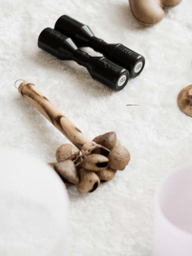 Sound healing instruments, including crystal singing bowls, tuning forks, and wave drums, arranged in a serene setting for meditation and vibrational therapy.