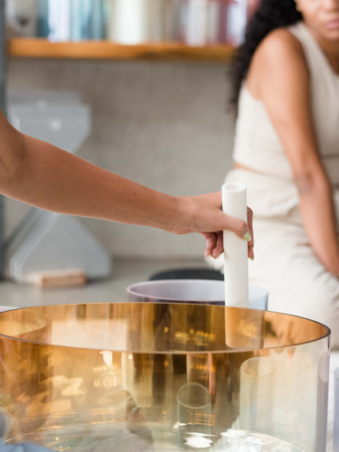 Image of a sound healing training session in Los Angeles, featuring participants engaging with crystal singing bowls and sound bath instruments for vibrational healing.